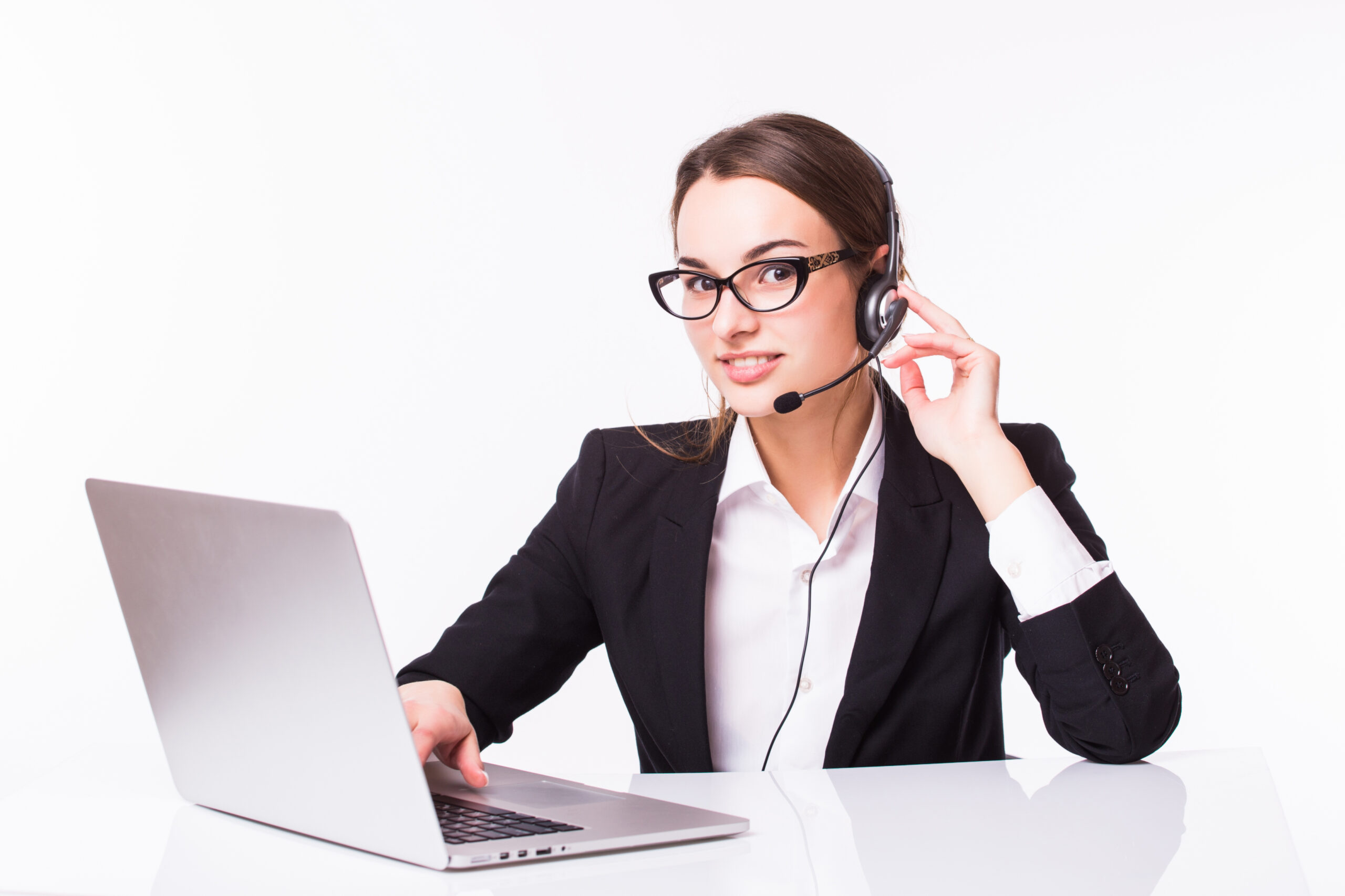 Portrait of happy smiling cheerful beautiful young support phone operator in headset with laptop over white background